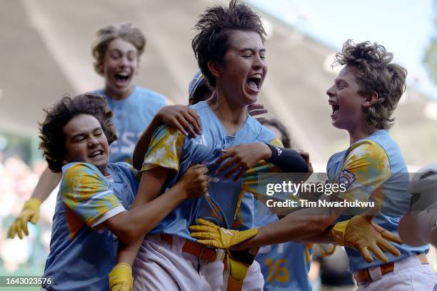 Louis Lappe of the West Region team from El Segundo, California celebrates with teammates after hitting a walk-off home run to defeat the Caribbean...