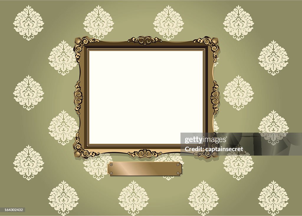 Ornate frame and plaque against vintage wallpaper