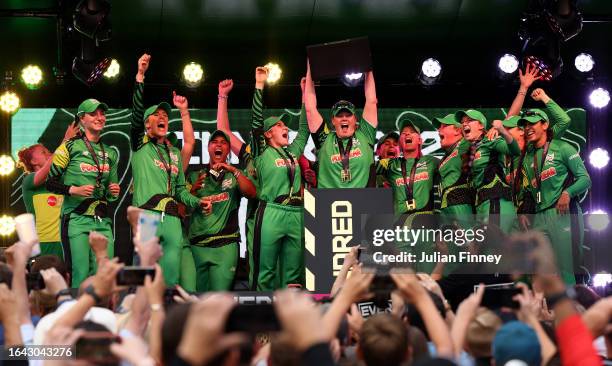 Anya Shrubsole of Southern Brave lifts The Hundred Winners Trophy as she celebrates with teammates after defeating Northern Superchargers during The...