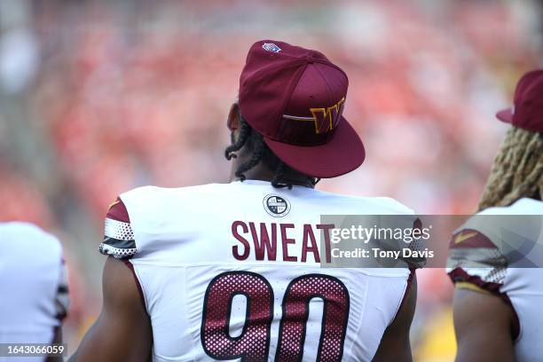 Montez Sweat of the Washington Commanders watches on as his team plays a preseason game against the Cincinnati Bengals at FedExField on August 26,...