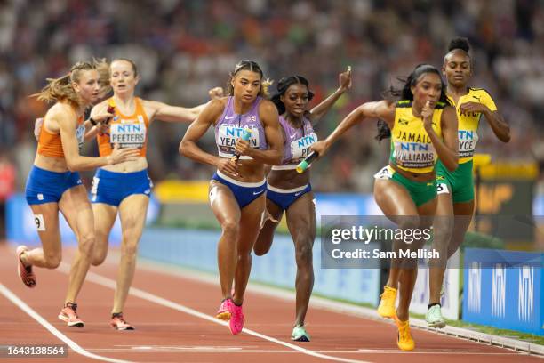 Nicole Yeargin receives the baton from Ama Pipi of Team Great Britain in the women's 4x400m relay final during day nine of the World Athletics...