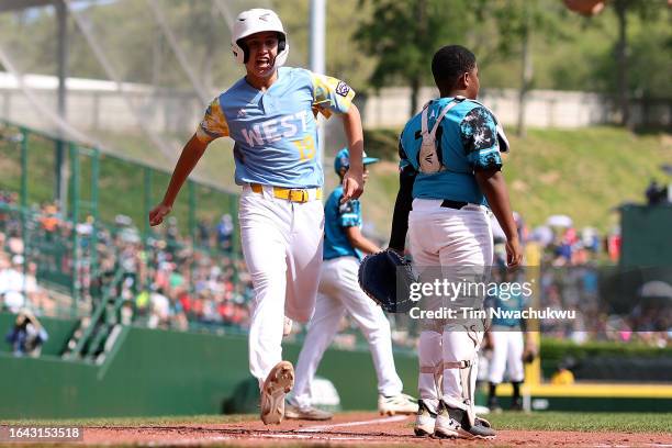 Louis Lappe of the West Region team from El Segundo, California scores a run during the first inning against the Caribbean Region team from...