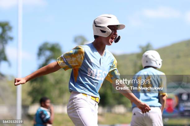 Louis Lappe of the West Region team from El Segundo, California reacts after scoring a run during the first inning against the Caribbean Region team...