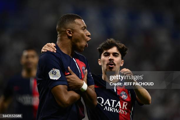 Paris Saint-Germain's French forward Kylian Mbappe celebrates next to Paris Saint-Germain's Portuguese midfielder Vitinha after scoring a goal during...