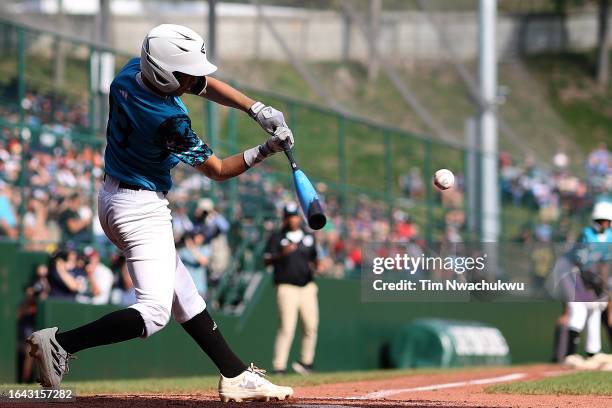 Nasir El-Ossaïs of the Caribbean Region team from Willemstad, Curacao hits a home run during the fifth inning against the West Region team from El...