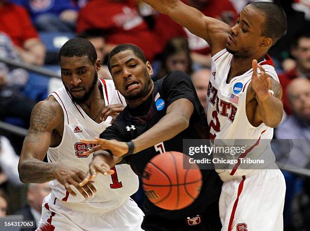 Temple Owls guard Khalif Wyatt is defended by North Carolina State Wolfpack forward Richard Howell and Lorenzo Brown in the second half Friday, March...
