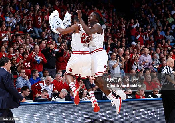 Victor Oladipo and Remy Abell of the Indiana Hoosiers celebrate a three point basket by Oladipo in the first half against the James Madison Dukes...
