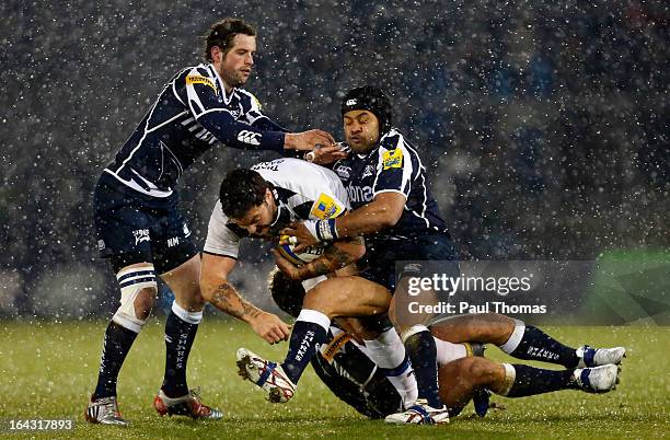 Matt Banahan of Bath is tackled by Nick MacLeod , Sam Tuitupou and Daniel Braid of Sale during the Aviva Premiership match between Sale Sharks and...