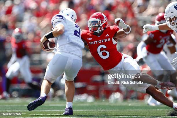 Defensive back Shaquan Loyal of the Rutgers Scarlet Knights sacks quarterback Ben Bryant of the Northwestern Wildcats during the second half of a...