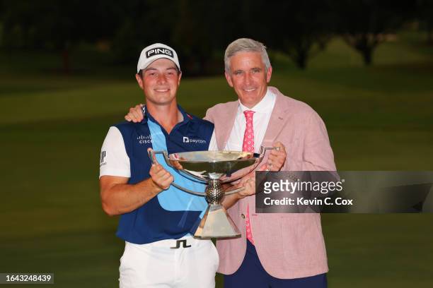 Viktor Hovland of Norway celebrates with the FedExCup and PGA Tour Commissioner Jay Monahan after winning the TOUR Championship at East Lake Golf...