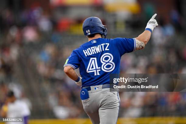 Spencer Horwitz of the Toronto Blue Jays celebrates as he runs the bases after hitting a fourth inning solo home run against the Colorado Rockies at...
