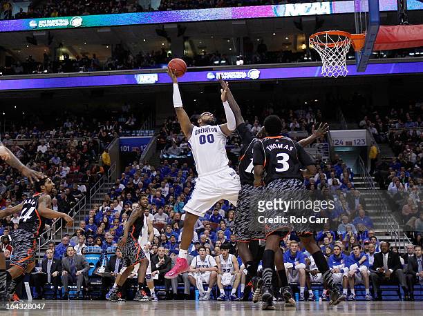 Gregory Echenique of the Creighton Bluejays looks to shoot against Cheikh Mbodj of the Cincinnati Bearcats in the second half during the second round...