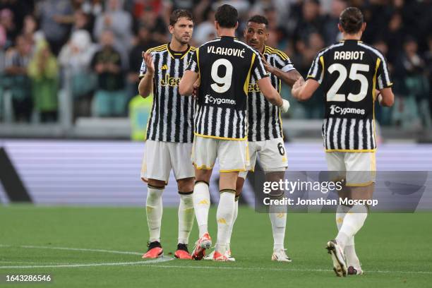 Dusan Vlahovic of Juventus celebrates with team mates Manuel Locatelli and Danilo after scoring to level the game at 1-1 during the Serie A TIM match...