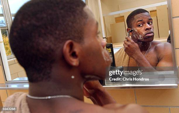 Pfc. Leroy Mikell of Columbus, Georgia shaves in his barracks November 14, 2002 in Ft. Bragg, North Carolina. Ft. Bragg, one of the country's main...