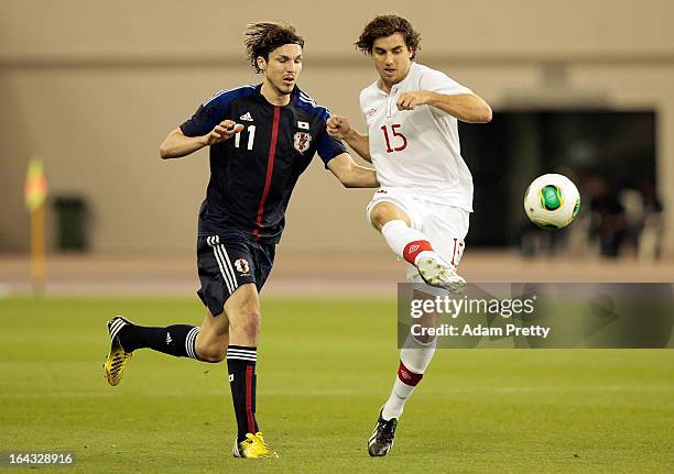 Mike Havenaar of Japan challenges Dejan Jakovic of Canada during the international friendly match between Japan and Canada at Khalifa International...