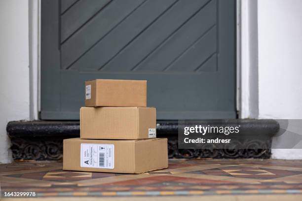 packages left on the porch of a house - packaging boxes stock pictures, royalty-free photos & images