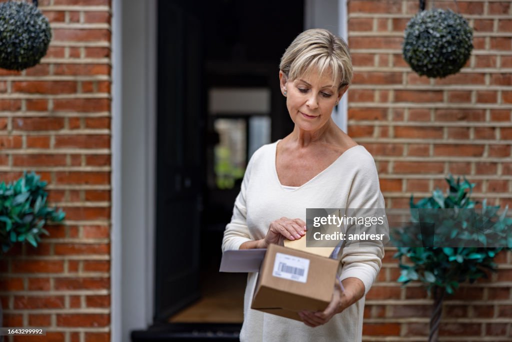 Senior man receiving an e-commerce package in the mail