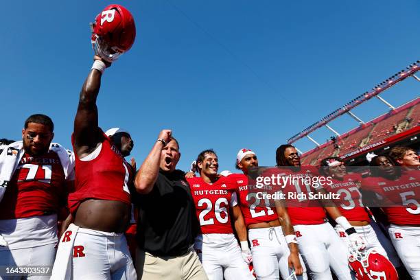 Head coach Greg Schiano of the Rutgers Scarlet Knights celebrates with his team after a 24-7 victory over the Northwestern Wildcats in a college...