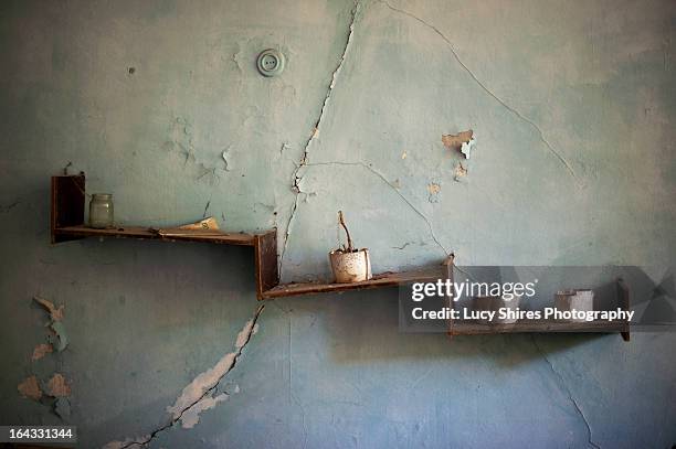 crooked shelves in an abandoned building - lucy shires stockfoto's en -beelden