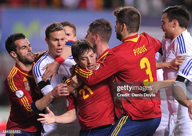Gerard Pique , David Silva and Alvero Negredo of Spain tussle with Niklas Moisander of Finland during the FIFA 2014 World Cup Qualifier between Spain...