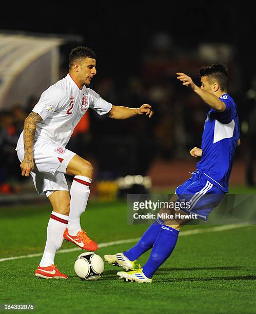 Kyle Walker of England is tackled by Matteo Vitaioli of San Marino during the FIFA 2014 World Cup Qualifier Group H match between San Marino and...