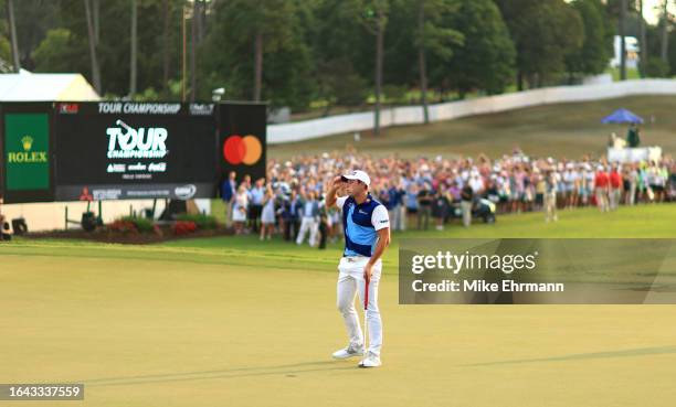 Viktor Hovland of Norway celebrates winning the FedExCup on the 18th green during the final round of the TOUR Championship at East Lake Golf Club on...