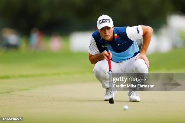 Viktor Hovland of Norway lines up a putt on the 12th green during the final round of the TOUR Championship at East Lake Golf Club on August 27, 2023...