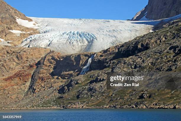 glacier and waterfall in prince christian sound, greenland - prince christian sound greenland stock pictures, royalty-free photos & images