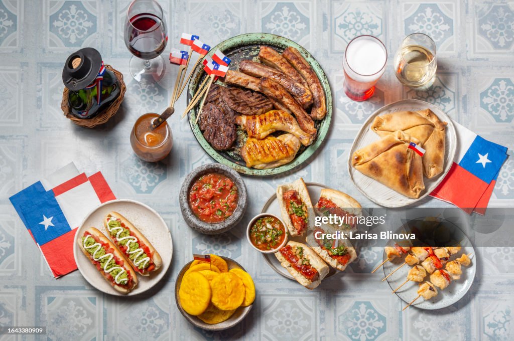 Chilean independence day table with traditional festive food for fiestas patrias. Dish and drink on 18 September party.