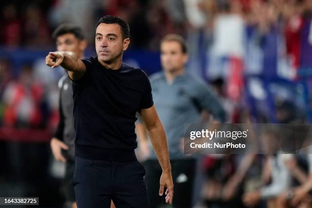 Xavi Hernandez head coach of Barcelona gives instructions during the LaLiga EA Sports match between CA Osasuna and FC Barcelona at Estadio El Sadar...