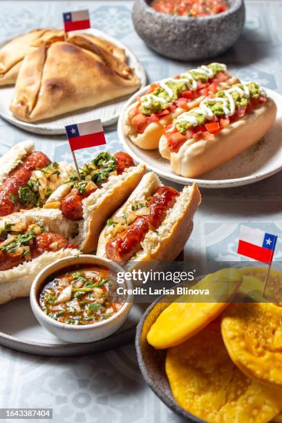 chilean traditional food for independence day - chorinan, empanadas de pino, sopaipollas and completos italianos - completo stock pictures, royalty-free photos & images