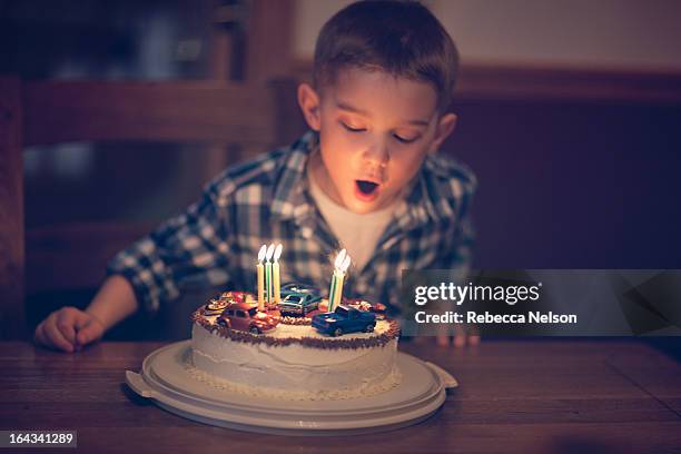 little boy blowin out birthday candles - kids birthday stock pictures, royalty-free photos & images