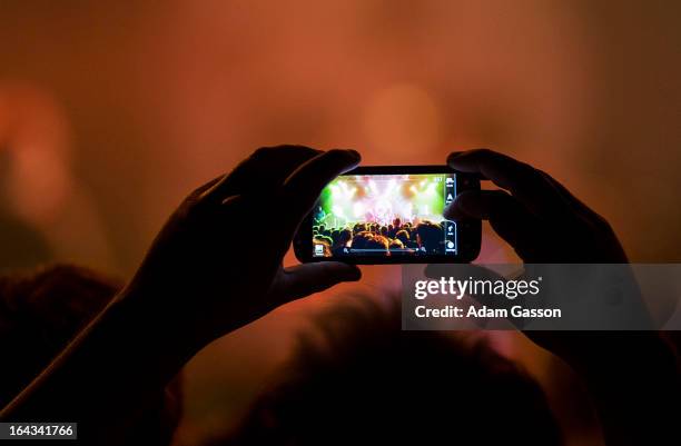 Fan takes a photograph on their mobile phone as The Gaslight Anthem perform at O2 Academy on March 22, 2013 in Bristol, England.