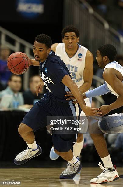 Darrun Hilliard of the Villanova Wildcats drives against Dexter Strickland of the North Carolina Tar Heels in the first half during the second round...