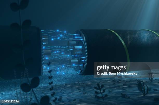 close-up of a cutaway undersea cable with glowing fiberglass on the seabed. cable for transmission of electricity and internet under the water of the ocean. - onderzee stockfoto's en -beelden