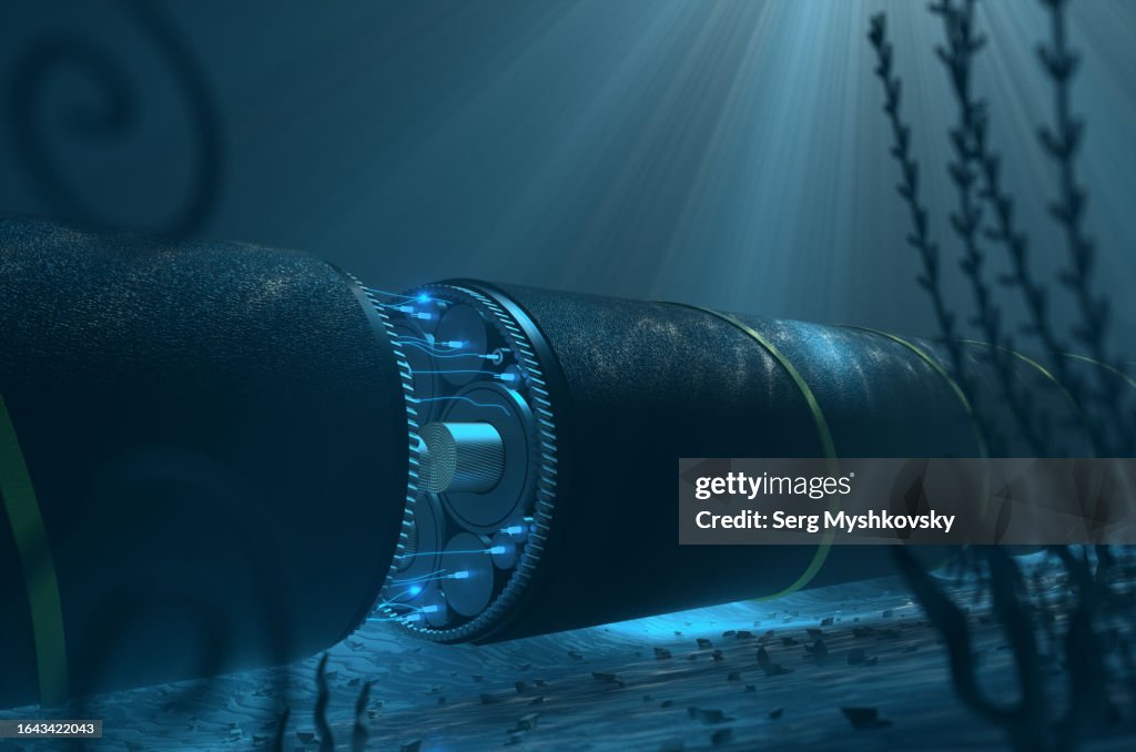Close-up of a cutaway undersea cable with glowing fiberglass on the seabed. Cable for transmission of electricity and internet under the water of the ocean.