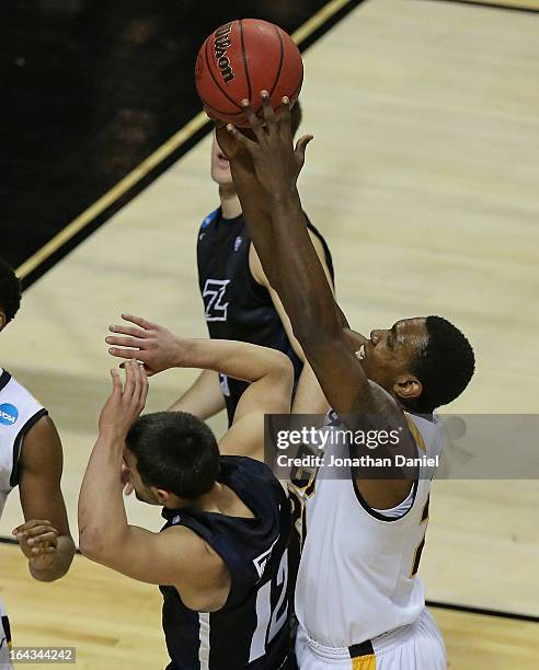 Treveon Graham rebounds over Carmelo Betancourt of the VCU Rams of the Akron Zips during the second round of the 2013 NCAA Men's Basketball...