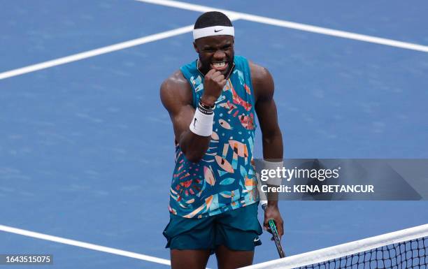 S Frances Tiafoe reacts after defeating Australia's Rinky Hijikata during the US Open tennis tournament men's singles round of 16 match at the USTA...