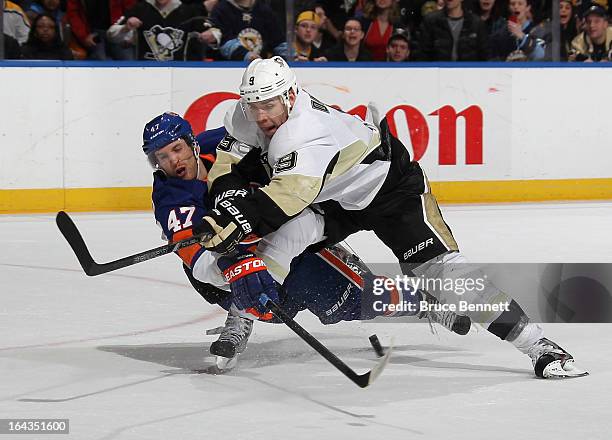 Andrew MacDonald of the New York Islanders stops Pascal Dupuis of the Pittsburgh Penguins from shooting at the empty net in the closing seconds of...