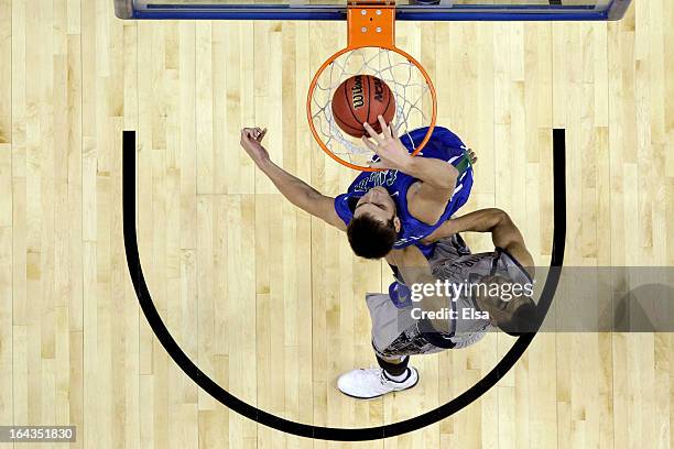 Chase Fieler of the Florida Gulf Coast Eagles dunks in the second half against Mikael Hopkins of the Georgetown Hoyas during the second round of the...