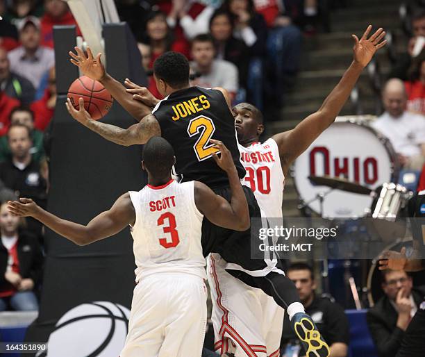 Iona's Lamont Jones drives to the basket as Ohio State's Shannon Scott and Evan Ravenel defend during the first half in the second round of the NCAA...