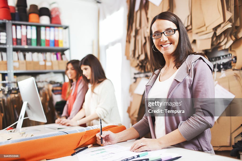 Clothes designer in her small business studio.
