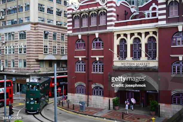 street view in western market and tram, central district, hong kong - sheung wan stock pictures, royalty-free photos & images