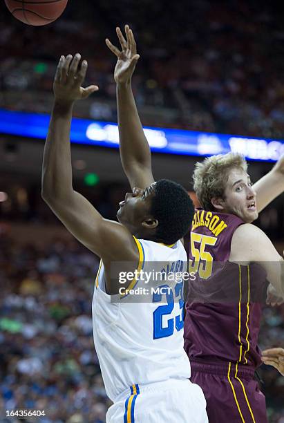 Tony Parker of UCLA and Elliott Eliason of Minnesota battle for a rebound in the first half of their game in the NCAA Tournament second round game on...