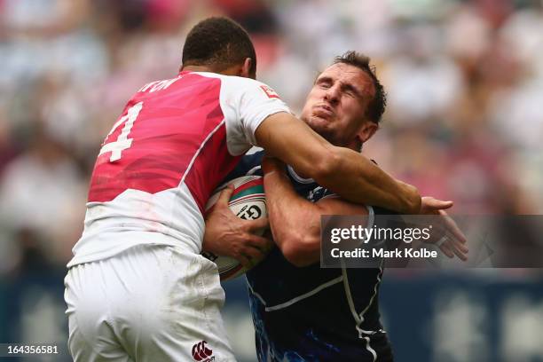 Darren Gillespie of Scotland is tackled during the match between England and Scotland on day two of the 2013 Hong Kong Sevens at Hong Kong Stadium on...