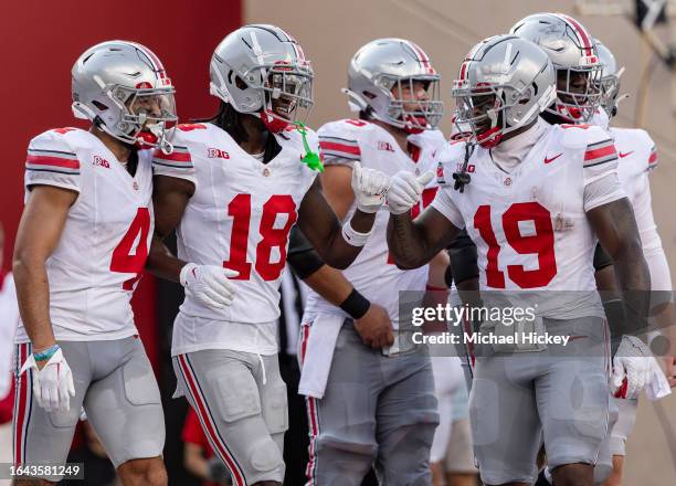 Marvin Harrison Jr. #18 and Chip Trayanum of the Ohio State Buckeyes react during the game against the Indiana Hoosiers at Memorial Stadium on...