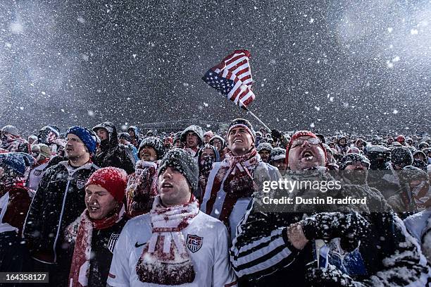 Fans of the United States national team cheer, wave a flag, and sing as snow falls during a FIFA 2014 World Cup Qualifier match between Costa Rica...