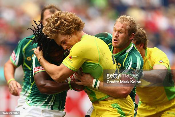 Jesse Parahi of Australia is tackled during the match between Australia and South Africa on day two of the 2013 Hong Kong Sevens at Hong Kong Stadium...