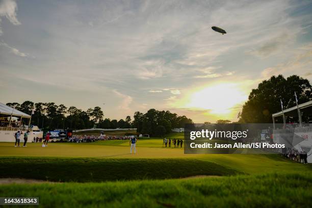 Viktor Hovland of Norway lines up his putt on the green of hole while the Goodyear Blimp flies overhead during the final round of the TOUR...