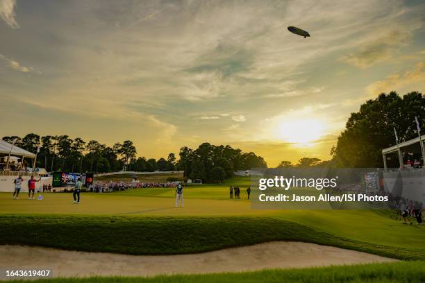 Viktor Hovland of Norway lines up his putt on the green of hole while the Goodyear Blimp flies overhead during the final round of the TOUR...